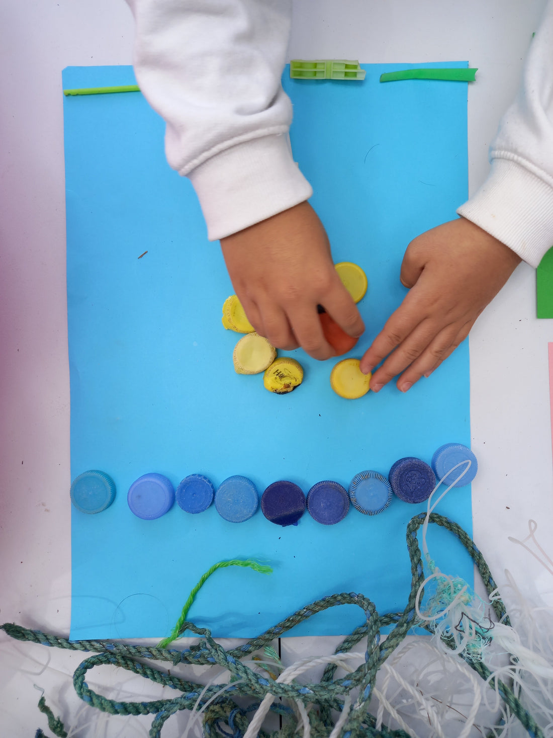 Children sorting and building with recycled microplastic fragments at the Odyssey Innovation and Artemisia workshop at VeganFest Malta 2026