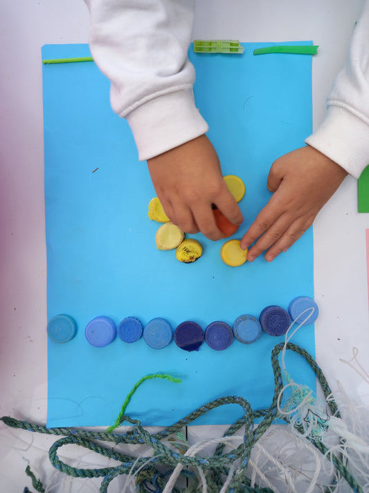 Children sorting and building with recycled microplastic fragments at the Odyssey Innovation and Artemisia workshop at VeganFest Malta 2026