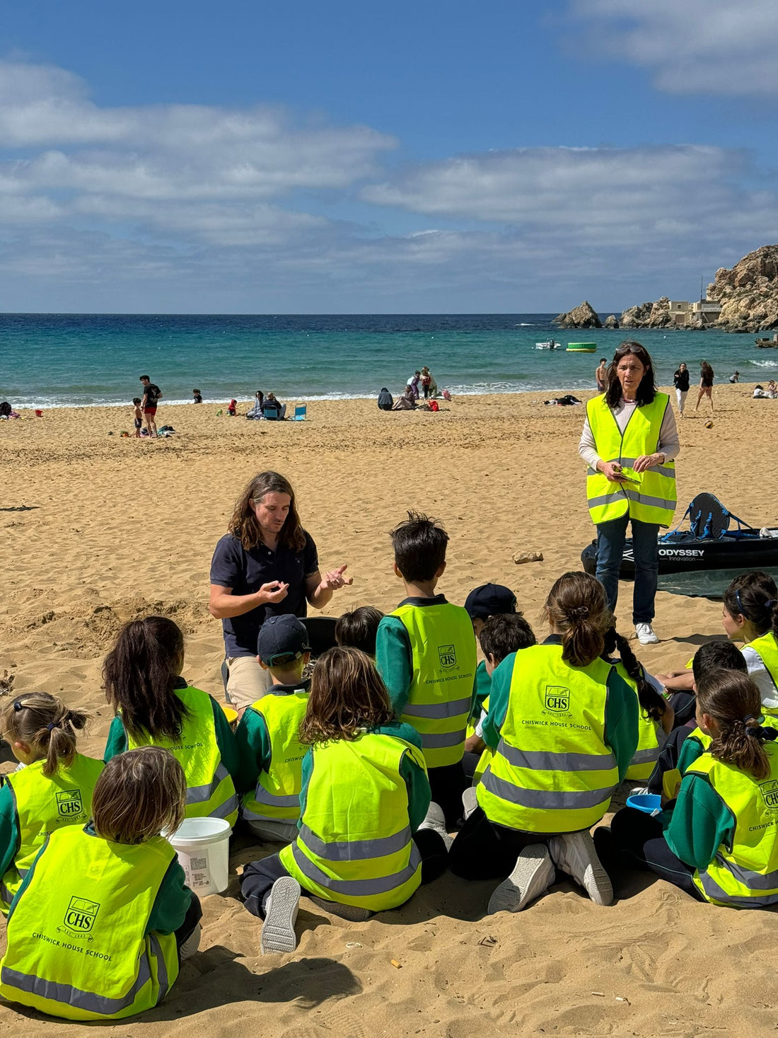 Children from Chiswick House School using Scuttle the Cuttle to collect microplastics at Għajn Tuffieħa beach in Malta — Little Pickers campaign by Odyssey Innovation