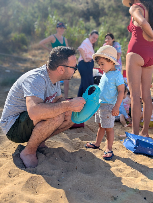 Ten toddlers on Golden Sands beach in Malta collecting microplastic with Scuttles at a birthday beach clean