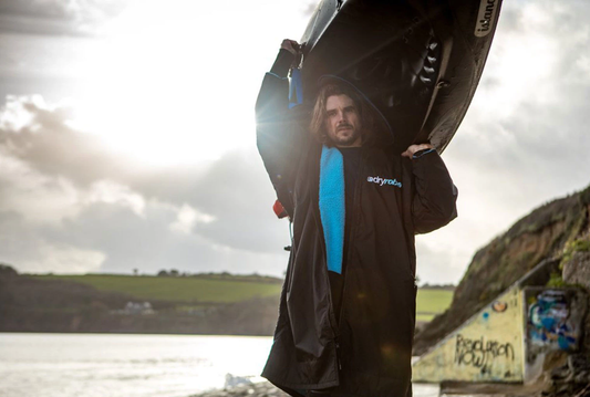 Rob Thompson, founder of Odyssey Innovation, holding recycled marine plastic products during a beach clean